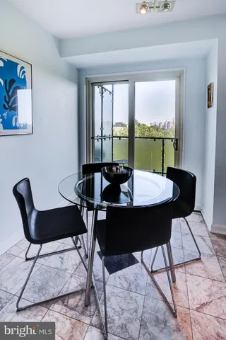 a view of a refrigerator in kitchen and an empty room