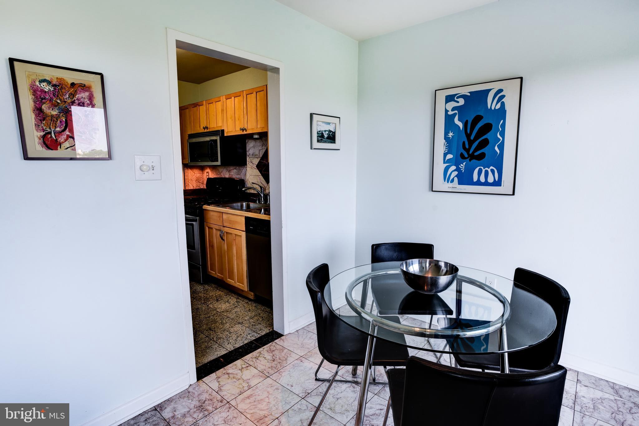 4201 Cathedral Avenue Northwest, Unit 1411E Washington, DC 20016 - Photo 22 of 66 a dining room with furniture and window
