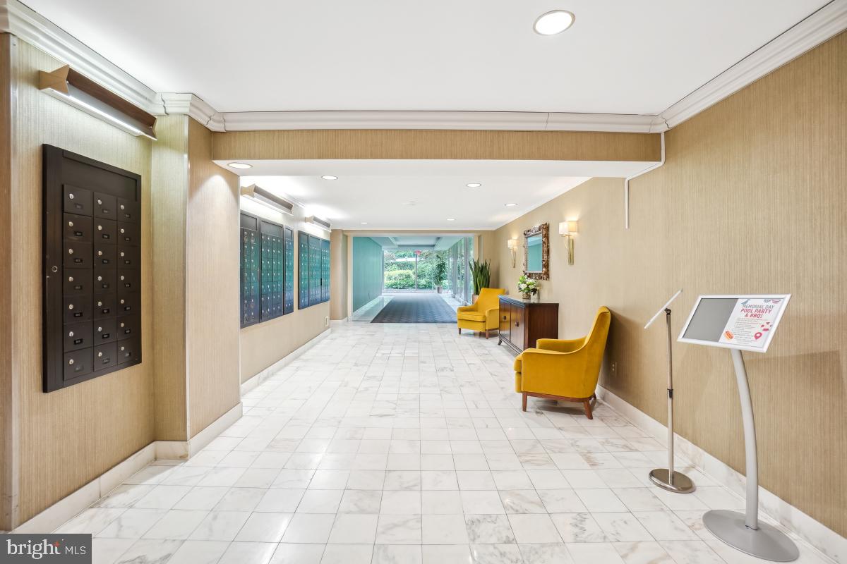 4201 Cathedral Avenue Northwest, Unit 1411E Washington, DC 20016 - Photo 44 of 66 a bed room with a bed and glass window