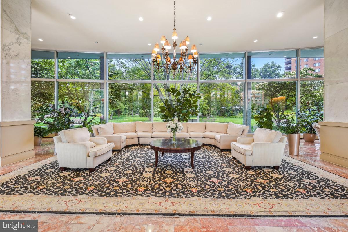 4201 Cathedral Avenue Northwest, Unit 1411E Washington, DC 20016 - Photo 7 of 66 a living room with patio furniture and a chandelier