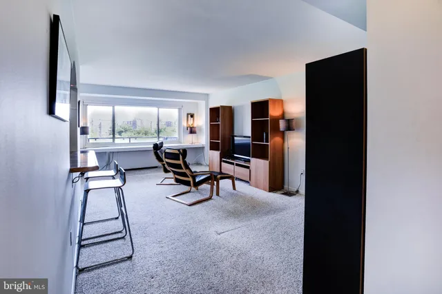 a living room with furniture and a piano