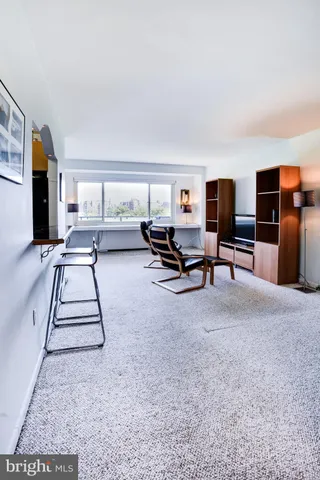 a living room with furniture and a piano