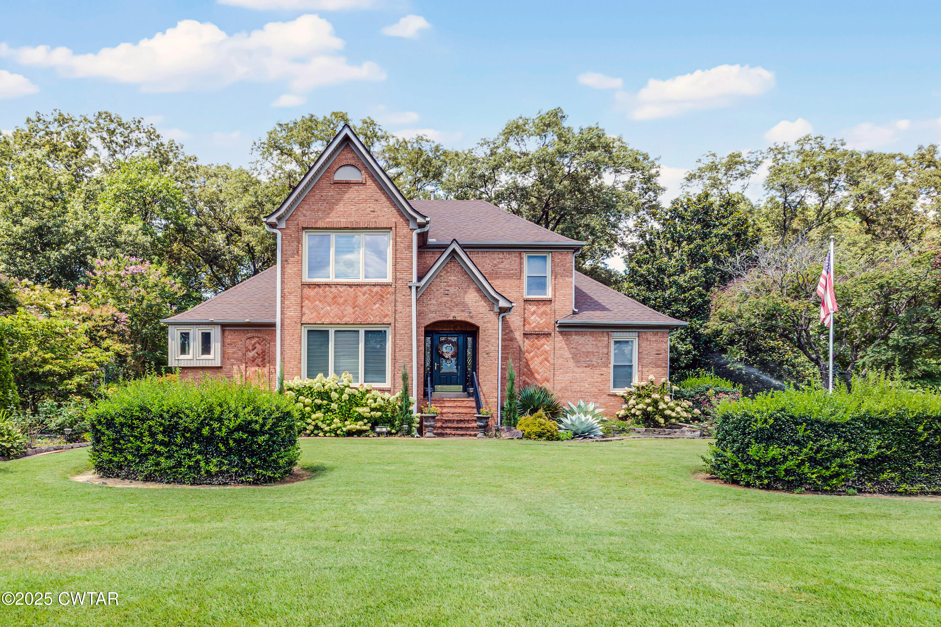 a front view of a house with garden