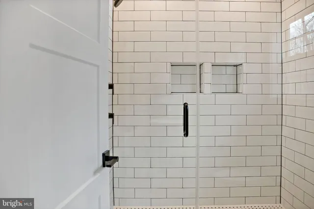 a bathroom with a wooden floor and a window