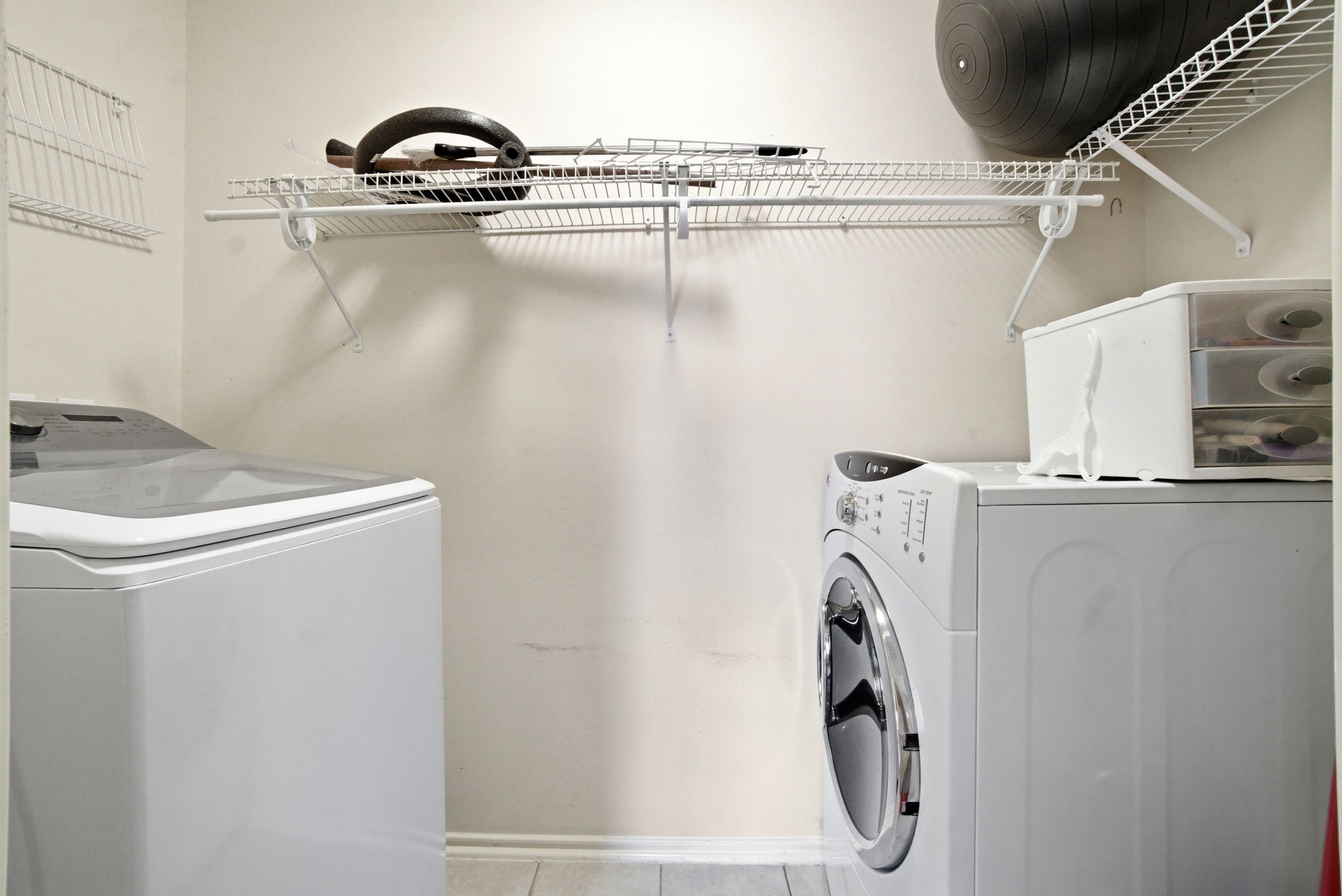 1607 Redbud Grove Court Conroe, TX 77301 - Photo 12 of 21 Dedicated laundry space with storage shelving