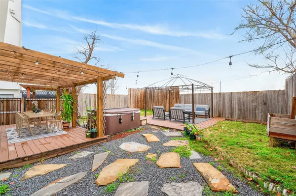 a backyard of a house with yard table and chairs