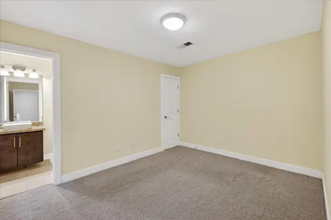 a living room with furniture flat screen tv and wooden floor