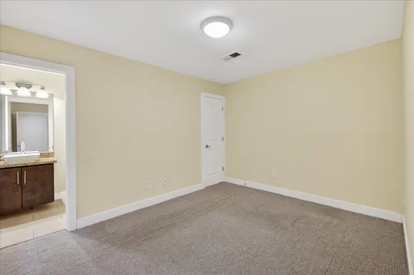 a living room with furniture flat screen tv and wooden floor