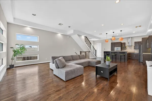 a living room with furniture and wooden floor