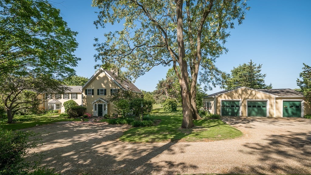 466 Bridge Street Hamilton, MA 01982 - Photo 3 of 40 a front view of a house with a yard and trees