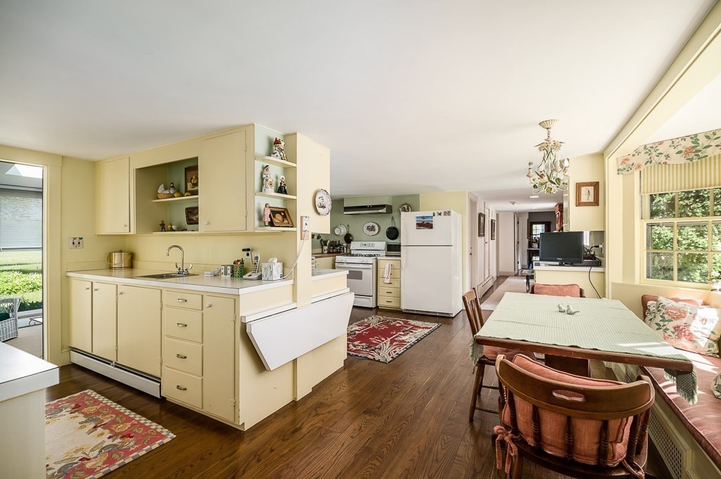 466 Bridge Street Hamilton, MA 01982 - Photo 9 of 40 a large white kitchen with cabinets