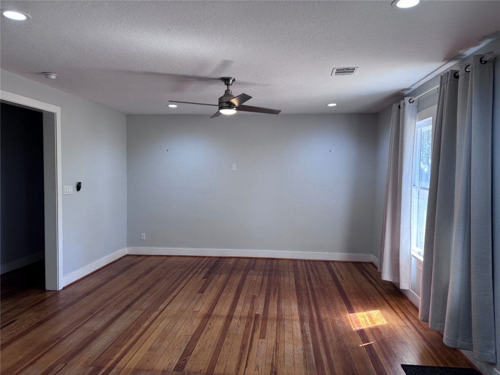 939 Knape Road La Grange, TX 78945 - Photo 35 of 37 Empty room featuring dark wood finished floors, recessed lighting, a ceiling fan, and a textured ceiling