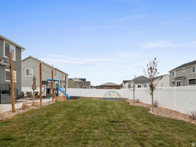 627 South Meade Street Mapleton, UT 84664 - Photo 20 of 48 Expansive backyard featuring a large grass area, white privacy fencing, and a concrete patio space