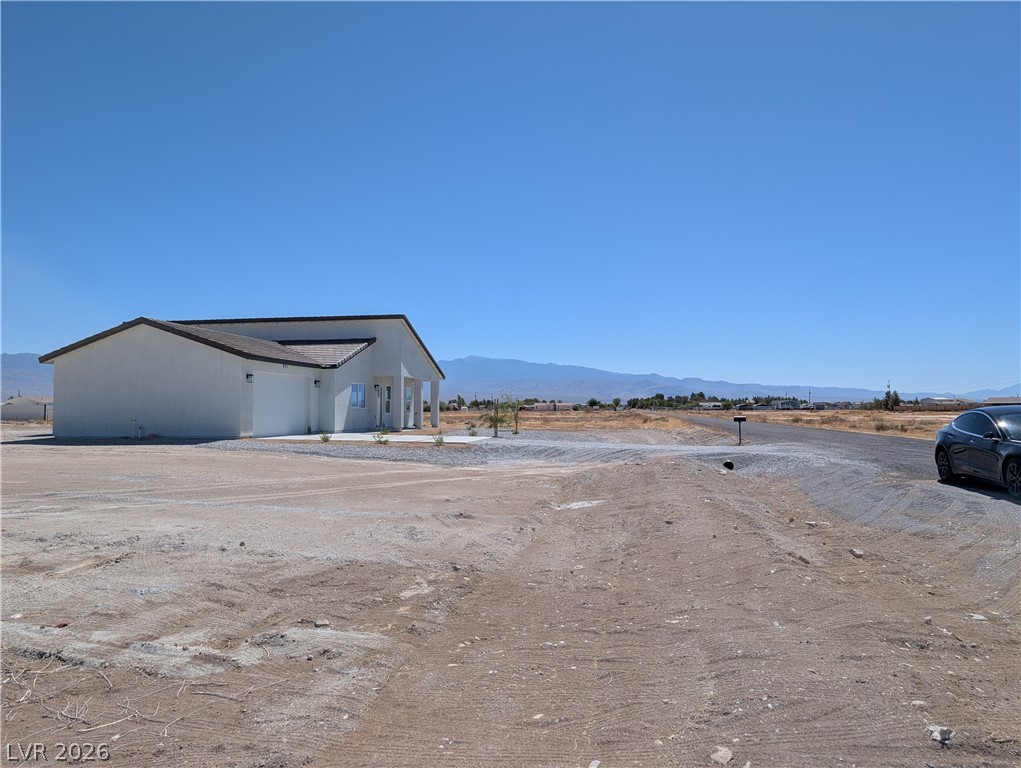 4670 Medicine Man Road Pahrump, NV 89048 - Photo 32 of 36 A contemporary desert residence with vast surrounding acreage, offering panoramic mountain views.