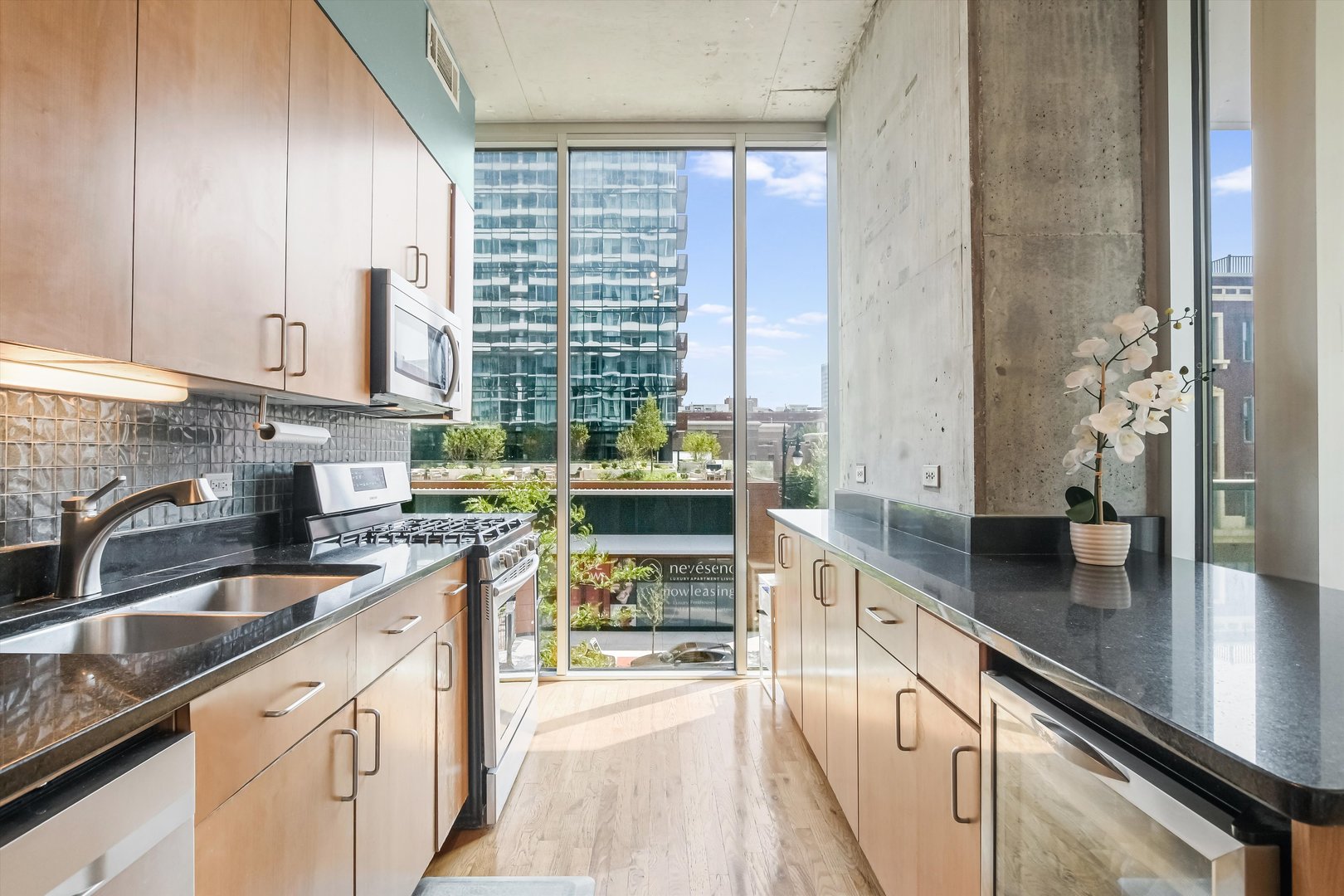 1720 South Michigan Avenue, Unit 308 Chicago, IL 60616 - Photo 5 of 23 a kitchen with kitchen island granite countertop a sink appliances cabinets and a counter top space