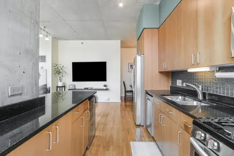 a kitchen with stainless steel appliances a stove a sink and a microwave