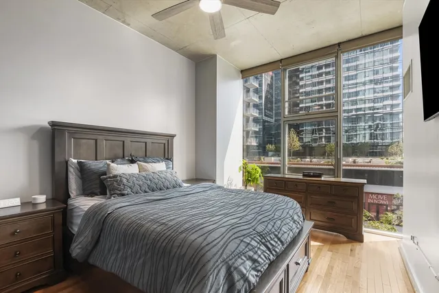 a bedroom with a large bed and a large window