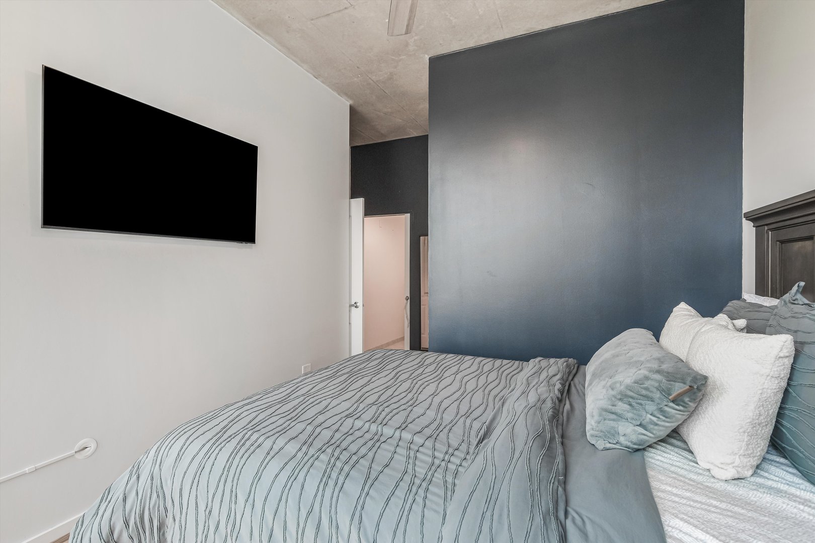 1720 South Michigan Avenue, Unit 308 Chicago, IL 60616 - Photo 10 of 23 a bedroom with a bed and a flat screen tv