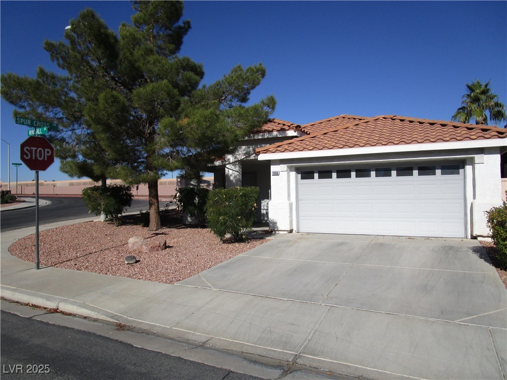 1966 Windfall Avenue Henderson, NV 89012 - Photo 1 of 13 Single story home with driveway, a garage, stucco siding, and a tiled roof