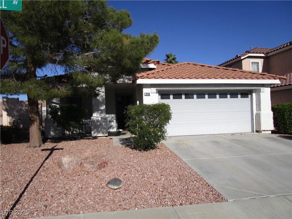 1966 Windfall Avenue Henderson, NV 89012 - Photo 13 of 13 Ranch-style home featuring a garage, stucco siding, concrete driveway, and a tiled roof