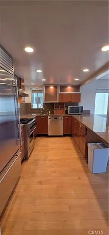 a large kitchen with stainless steel appliances lots of counter space