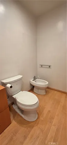 a white toilet sitting next to a bathroom sink