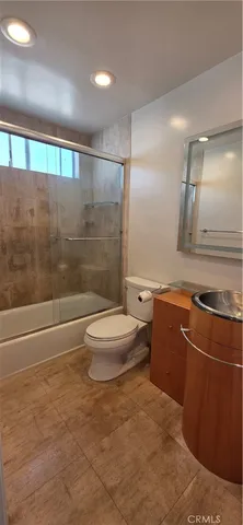 a bathroom with a toilet a sink and shower