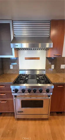a stove top oven sitting inside of a kitchen
