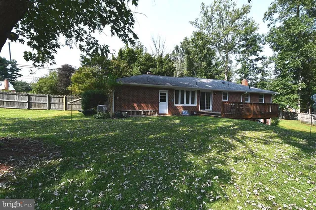 a view of a house with a yard and sitting area