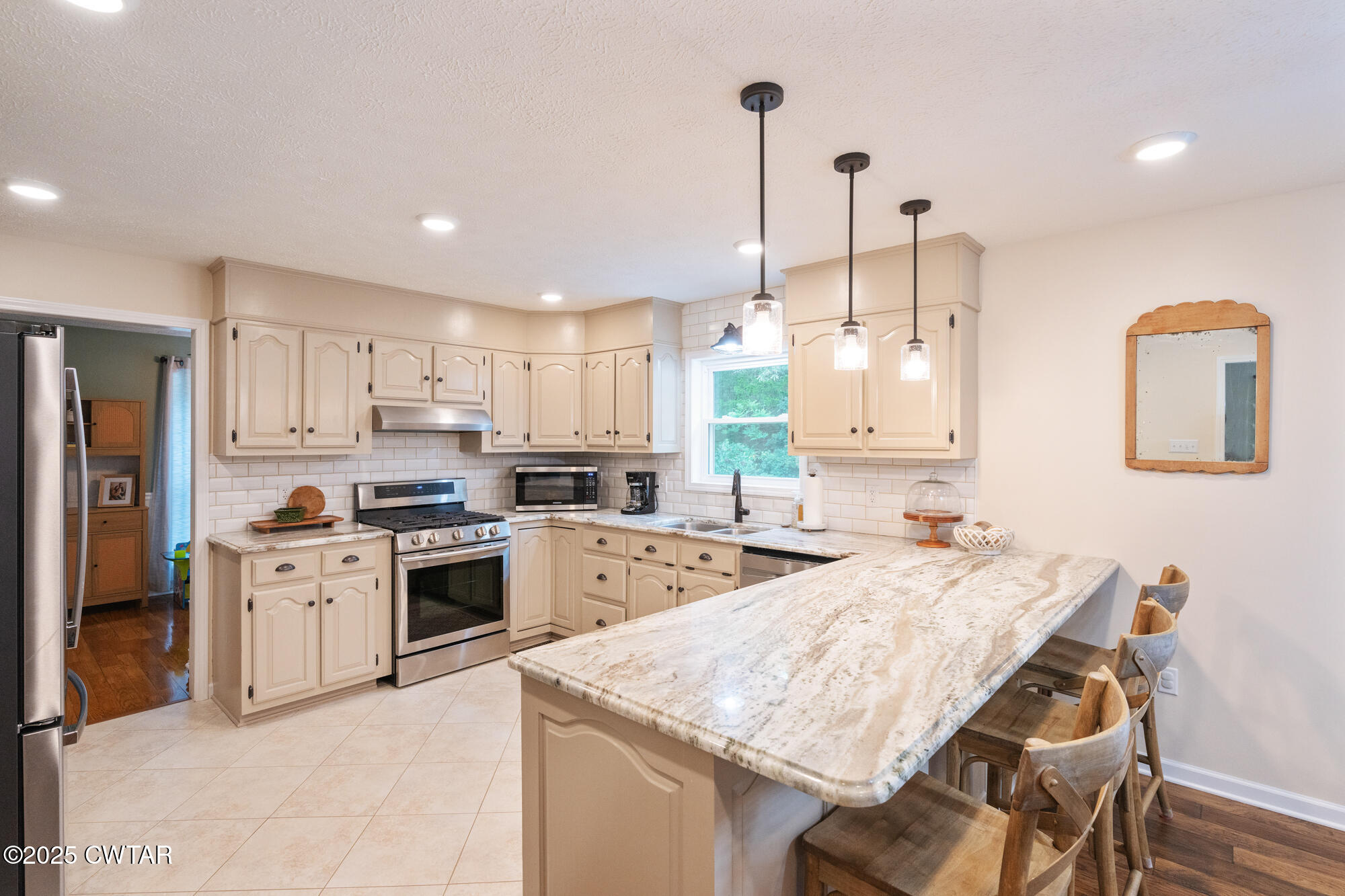 105 Center Hill-Wright Road Reagan, TN 38368 - Photo 17 of 42 a kitchen with stainless steel appliances kitchen island granite countertop a stove a sink a refrigerator a dining table and chairs with wooden floor