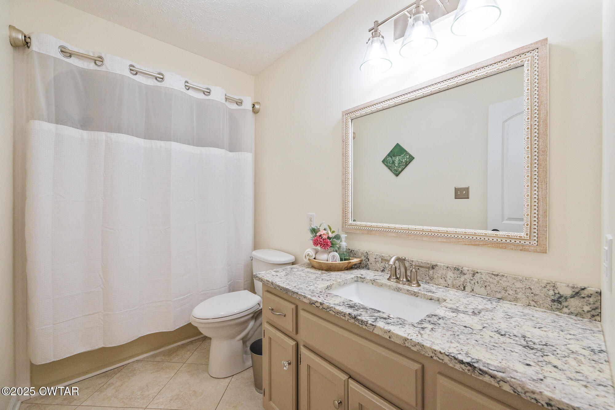 105 Center Hill-Wright Road Reagan, TN 38368 - Photo 23 of 42 a bathroom with a granite countertop sink a toilet and a mirror