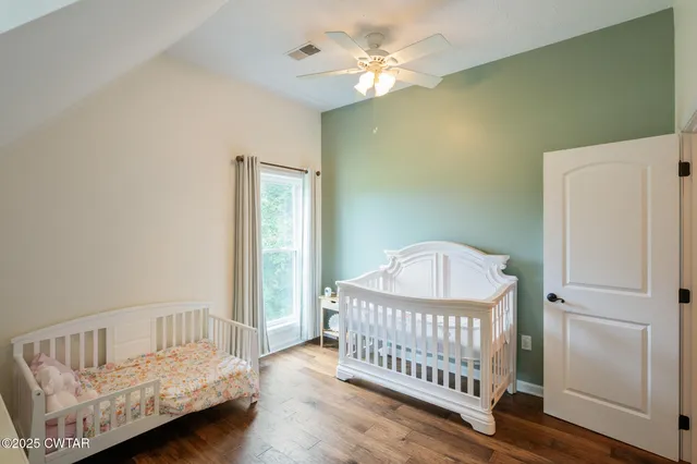 a bedroom with a bed and a fireplace