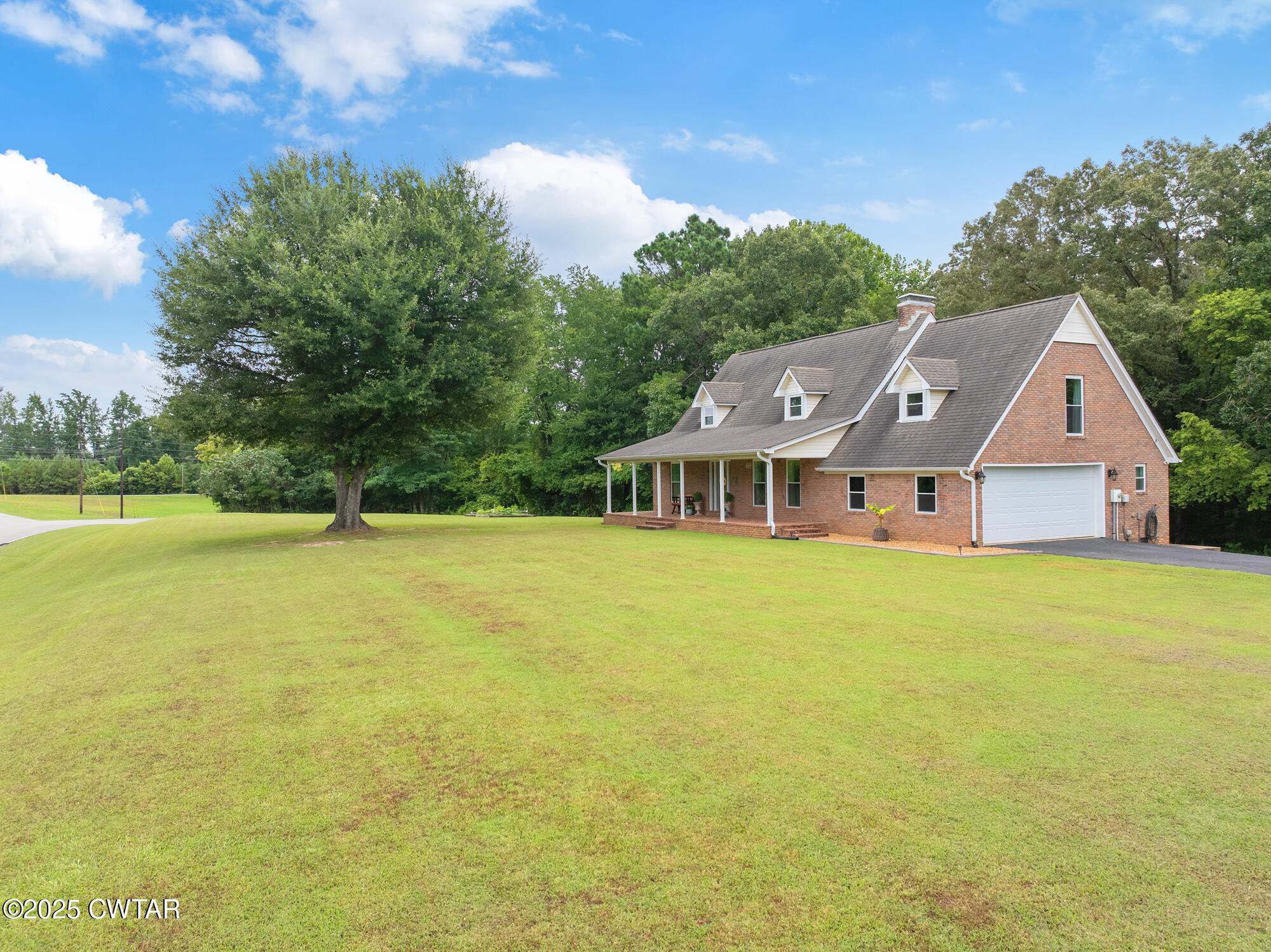 105 Center Hill-Wright Road Reagan, TN 38368 - Photo 4 of 42 a front view of house with yard and trees in the background