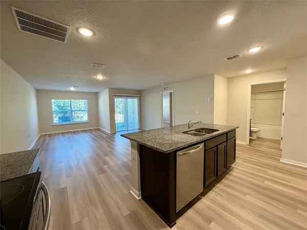 an open kitchen with a sink and dish washer
