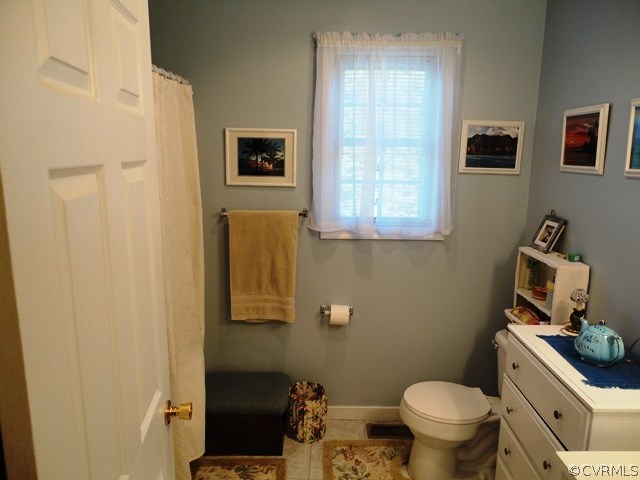 1585 Copper Line Road Bumpass, VA 23024 - Photo 17 of 24 a bathroom with a toilet sink and mirror