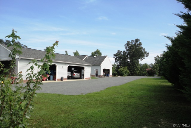 1585 Copper Line Road Bumpass, VA 23024 - Photo 21 of 24 a front view of a house with a garden