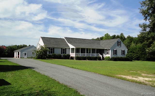 1585 Copper Line Road Bumpass, VA 23024 - Photo 3 of 24 a front view of a house with a garden and trees
