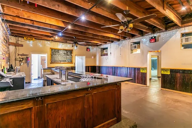 a kitchen with counter top space and wooden floor