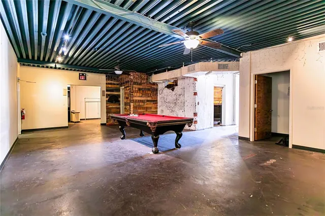 a sitting area with pool table and chairs