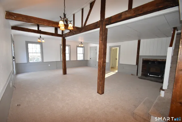 a view of a livingroom with a fireplace and window