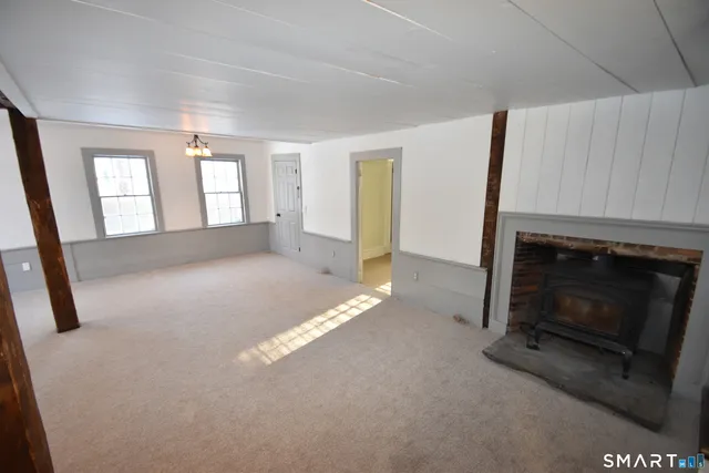 a view of empty room with window and fireplace