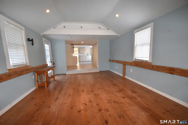wooden floor in an empty room with a window