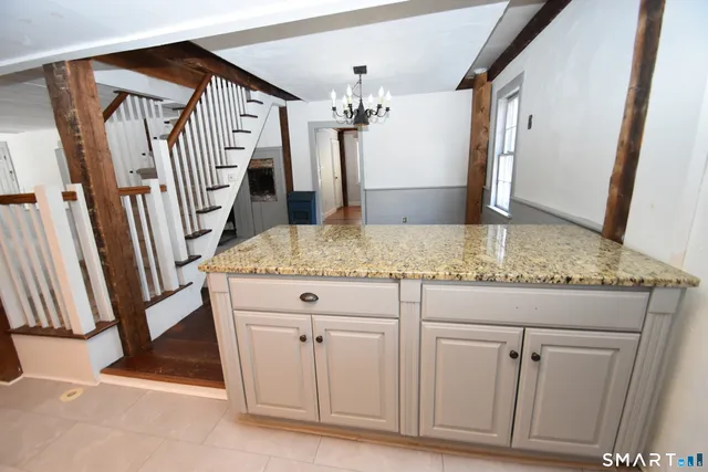 a view of a kitchen with granite countertop cabinets
