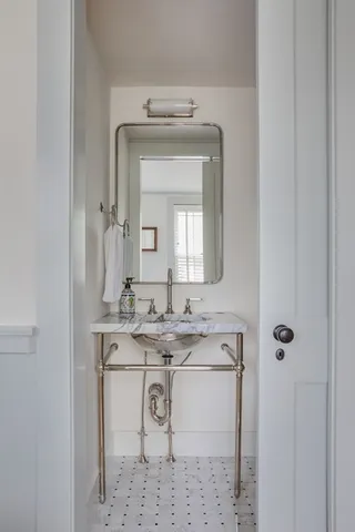 a bathroom with a sink vanity and mirror