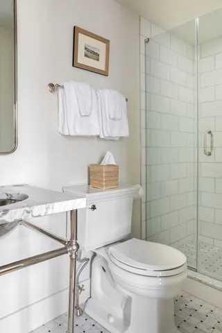 a bathroom with a toilet a sink and a shower