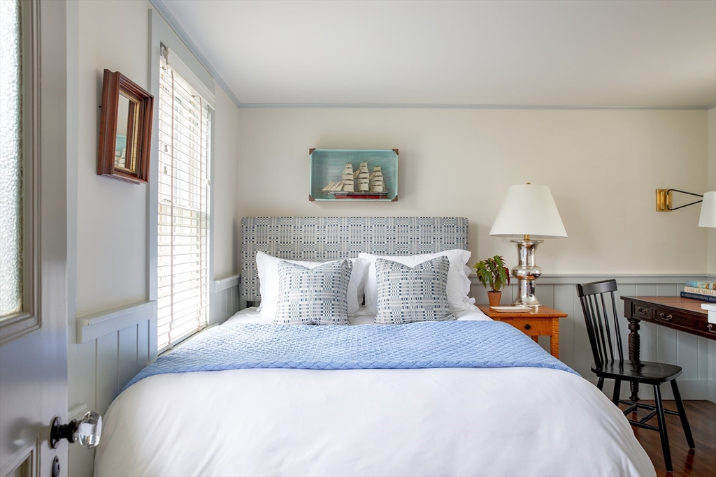 77 Sparks Avenue Nantucket, MA 02554 - Photo 24 of 30 a bedroom with a bed and wooden floor