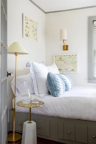 a bedroom with a bed and lamp