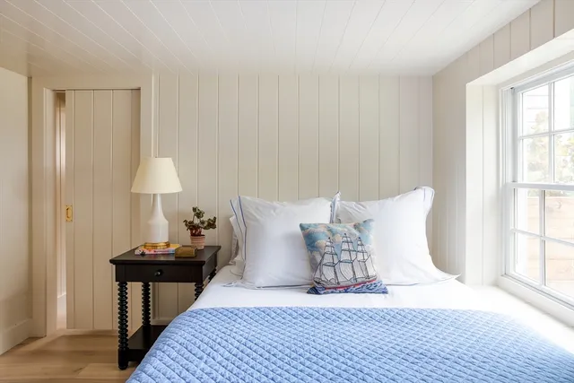 a bed room with a bed and a night stand