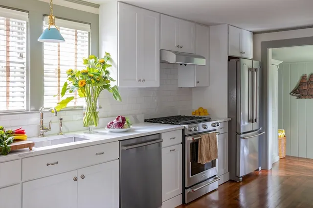 a kitchen with a sink stove and refrigerator