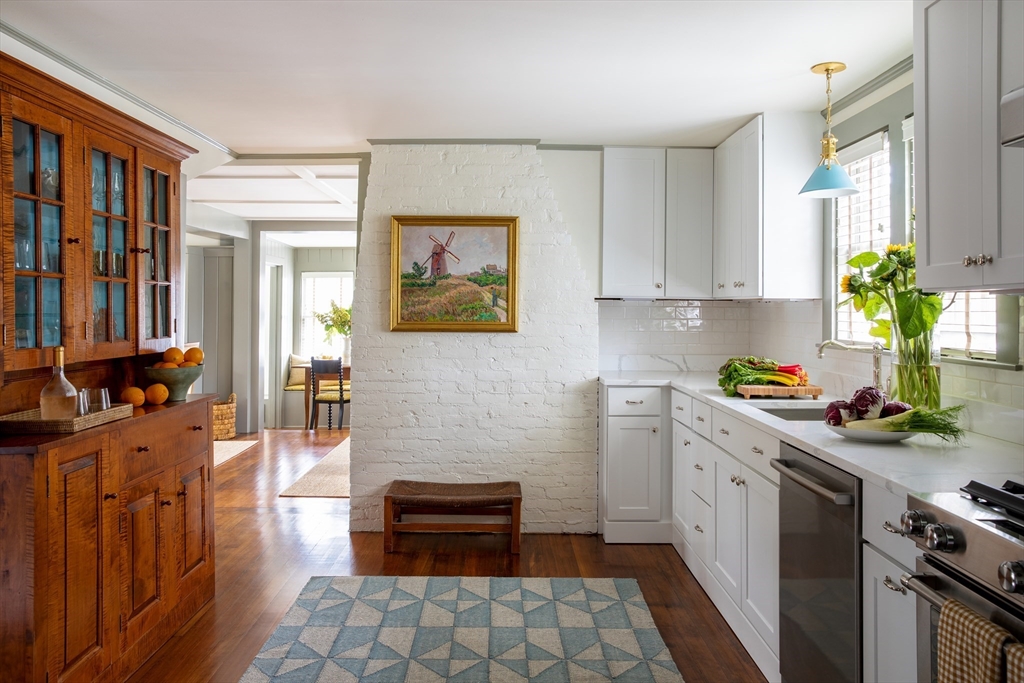 77 Sparks Avenue Nantucket, MA 02554 - Photo 6 of 30 a kitchen with stainless steel appliances a stove top oven a sink a counter space and cabinets